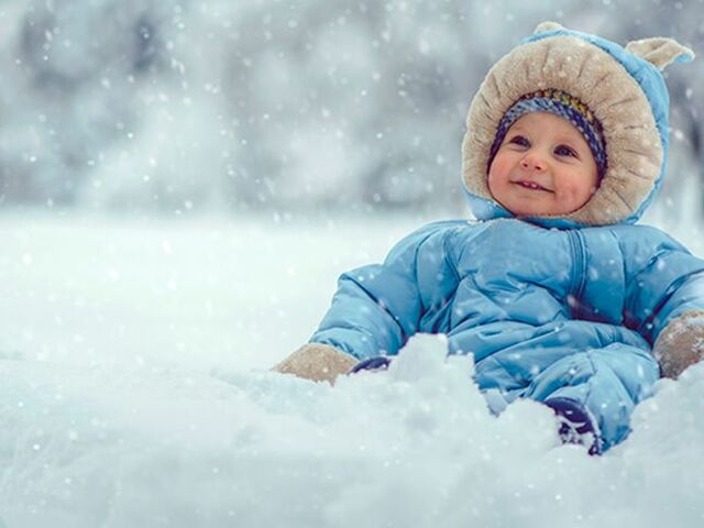 Un bimbo piccolo disteso sulla neve